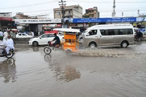 Vehicles passing through rainwater accumulated at IJP Road during rain in the Federal Capital