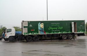 A Field Hospital trailer operated by the Health & Population Welfare Department, Government of Punjab, stationed on a rain-soaked road near Khana pull, the mobile unit launched under the Chief Minister of Punjab's initiative.