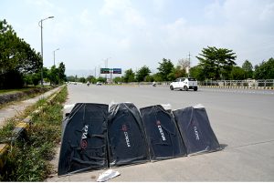 Black cloth screens of vehicles displayed at roadside to attract the customers on 9th Avenue.