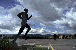 A silhouette of a running athlete statue stands against a dramatic monsoon sky filled with clouds over the Margalla Hills at the Pakistan Sports Complex in the Federal Capital.