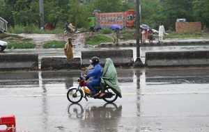 Vehicles passing through rainwater accumulated at IJP Road during rain in the Federal Capital