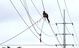 WAPDA staffer busy install new electricity cables along Lethrar Road.