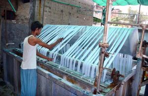A worker is busy routine work in a local cloth factory.