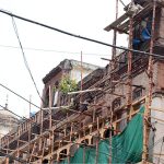 Workers are busy carrying out construction and restoration work on an old building in Anarkali Bazaar