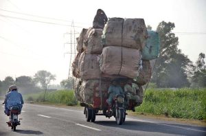 Gypsy people on the way on tricycle rickshaw at Naranwala Road heavily loaded with valuables they collected from different points.