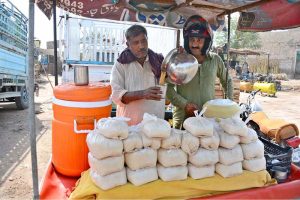 A vendor prepares and serves traditional drink Sattu to customers during scorching hot weather in the city.