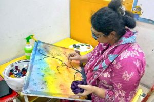Female artists showcase their creativity during a painting competition organized by the Knowledge of Art Academy and Lahore Grammar Academy in Model Town.