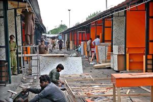 Workers are busy constructing stalls as reconstruction work continues at the H-9 Weekly Bazaar, which burnt in fire incident