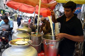 A street vendor sells seasonal fresh fruit jaaman (black berry) in the City