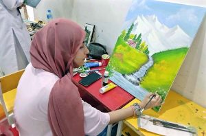 Female artists showcase their creativity during a painting competition organized by the Knowledge of Art Academy and Lahore Grammar Academy in Model Town.