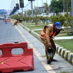 Cantonment Board (CB) staff paint footpaths along Walton Road as part of a city beautification drive