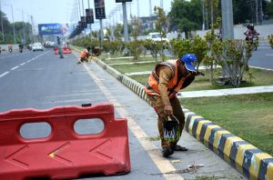 Cantonment Board (CB) staff paint footpaths along Walton Road as part of a city beautification drive