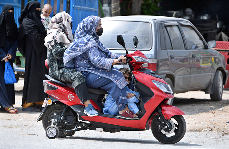 Women on wheels — Two women commuters ride a scooty in Federal Capital, reflecting a growing trend among female students and professionals who are embracing affordable, practical, and empowering mobility options