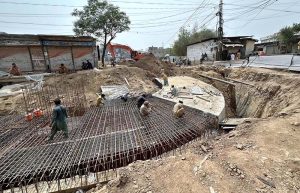 Workers busy laying steel reinforcement framework at a sewerage line construction site at Raja Bazaar Gunj Mandi, as development work continues to upgrade the city's underground drainage infrastructure.