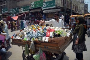 A crockery vendor displays tea cups for sale at the weekly Friday Bazaar (Jumma Bazaar).