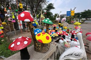 Decorative lawn ornaments and handcraft items are showcased for sale along Park Road.