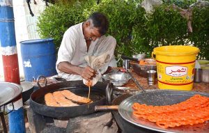 A vendor displaying traditional food item (Katlama) to attract the customers at his shop.
