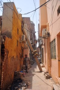 A dangerously leaning concrete electricity pole, supported only by a nearby house wall and a web of overhead power cables, carries multiple electricity meters and live wires, posing a serious threat to residents in the narrow street of Mohalla Qasab Pura near Khooni Burj. The pole has remained in a hazardous condition for nearly 10 days as pedestrians continue to pass beneath it and locals urge authorities to carry out immediate repairs