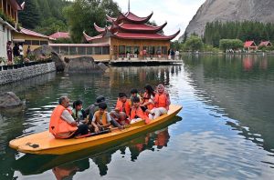 A family enjoys a boat ride on Shangrilla Lake in Skardu.