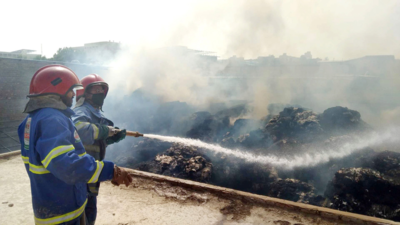 Firefighters struggle to control a fire that erupted at a cotton factory in the Site Area