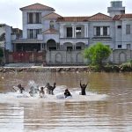 Children are playing in stagnant rainwater accumulated at Qasim Park