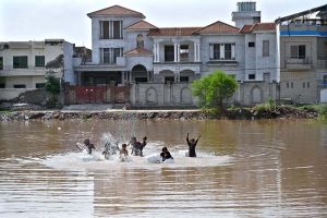 Children are playing in stagnant rainwater accumulated at Qasim Park