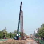 Labourers are busy construction work on Jaranwala Road with the help of heavy machineries during development work of Metro Project