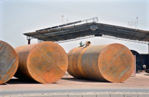 Workers are busy welding and fabricating underground oil storage tanks for petrol stations at a local engineering workshop.