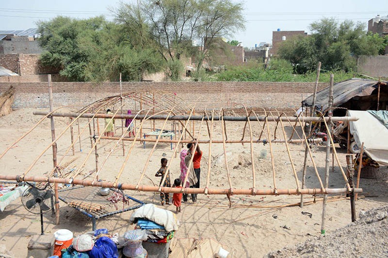 Gypsy families erect temporary shelters along the roadside to use as makeshift homes in the city