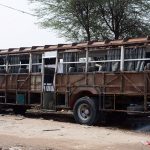 A worker welds the steel frame of a passenger bus during reconstruction and body refurbishment at a local vehicle workshop in the city
