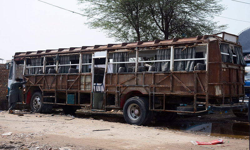 A worker welds the steel frame of a passenger bus during reconstruction and body refurbishment at a local vehicle workshop in the city