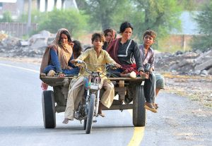A minor drives a poorly maintained motorcycle-cart carrying family members along the NLC Bypass, violating traffic rules and endangering lives by increasing the risk of a serious road accident.