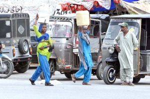 Gypsy women on their way carrying pots on their head after filling clean water at Husenabad.
