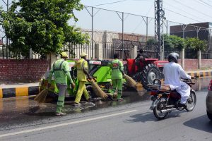 Sanitary workers wash LMQ Road during the "Saaf Suthra Punjab" cleanliness campaign to improve sanitation and maintain a clean environment in the city