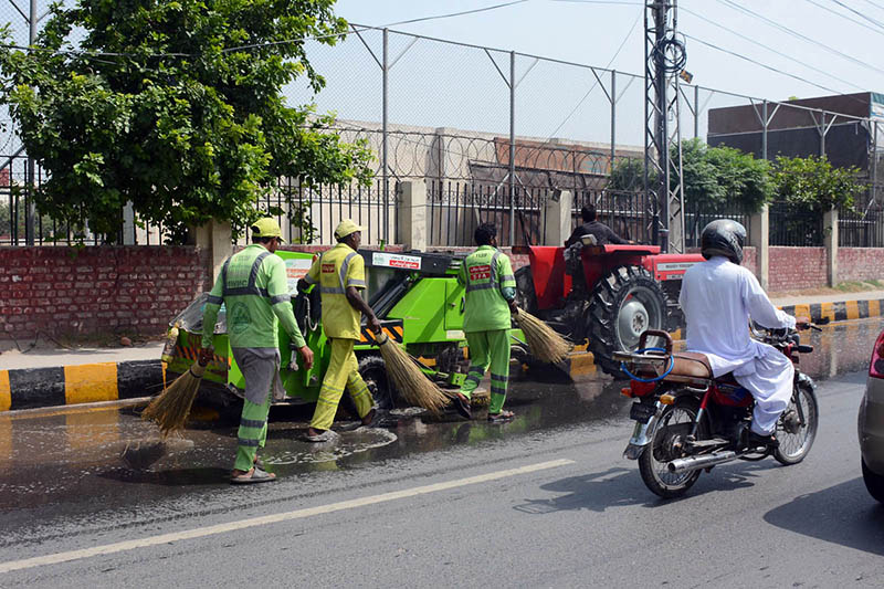 Sanitary workers wash LMQ Road during the "Saaf Suthra Punjab" cleanliness campaign to improve sanitation and maintain a clean environment in the city