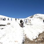 Tourists visit and enjoy the scenic beauty of Burzil Top (Burzil Pass), a historic mountain pass at an elevation of 13,808 feet in the Himalayas. The pass connects Astore Valley with the picturesque Minimarg and Domel regions and, before the partition of the subcontinent, served as a major caravan route linking Srinagar with Gilgit and Skardu