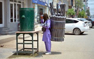 A vendor drinking water at Satellite Town Road during scorching hot weather in the city.