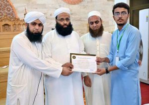Scholar Mufti Jahangir Abbasi distributes certificates among participants during the concluding ceremony of the Islamic Summer Camp at Jamia Masjid, C Block, Media Town.
