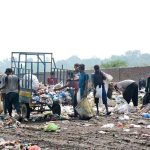 A large number of gypsy searching valuable items from garbage