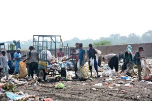 A large number of gypsy searching valuable items from garbage