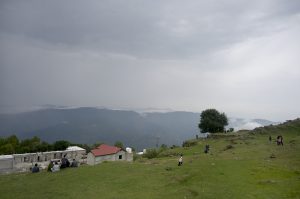 Visitors enjoy the pleasant weather at a village in the hilly resort town of Murree.