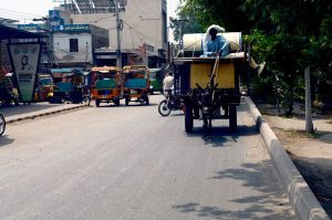 A man travels on a donkey cart carrying household belongings at 9 Number Chungi