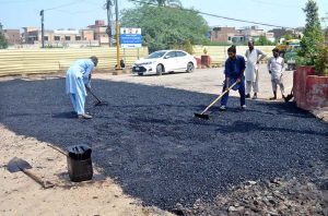 Labourers are busy repairing work of Jail Chowk during maintenance work.