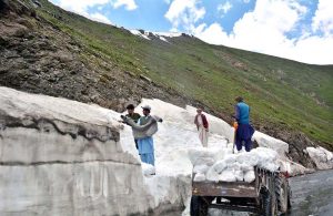 Tourists enjoy the crystal-clear, glacier-fed waters along the scenic riverside at Batakundi in Kaghan Valley.