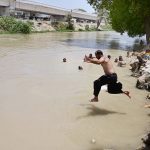 Residents dive into the Chanal Mori Canal to cool off and seek relief from the intense summer heat gripping the city