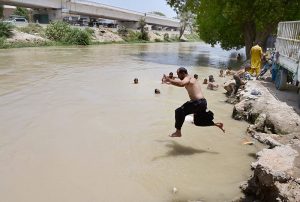 Residents dive into the Chanal Mori Canal to cool off and seek relief from the intense summer heat gripping the city