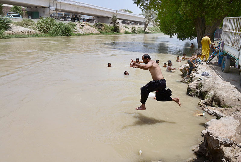 Residents dive into the Chanal Mori Canal to cool off and seek relief from the intense summer heat gripping the city