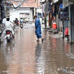 Rainwater accumulates in Landa Bazaar after rainfall in the city, causing inconvenience to residents and commuters
