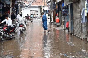 Rainwater accumulates in Landa Bazaar after rainfall in the city, causing inconvenience to residents and commuters