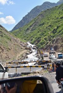 Tourists enjoy the crystal-clear, glacier-fed waters along the scenic riverside at Batakundi in Kaghan Valley.